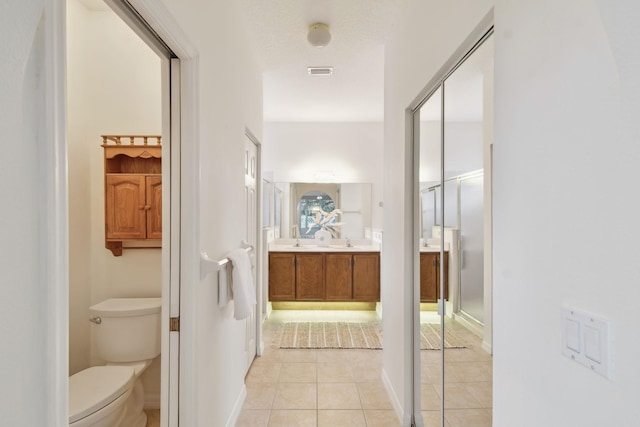 581 Boxwood Pl, Saint Augustine, FL 32086 - hallway featuring light tile patterned floors and a sink