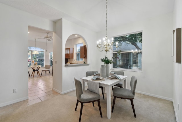 581 Boxwood Pl, Saint Augustine, FL 32086 - dining space with a chandelier, light carpet, light tile patterned flooring, arched walkways, and ceiling fan