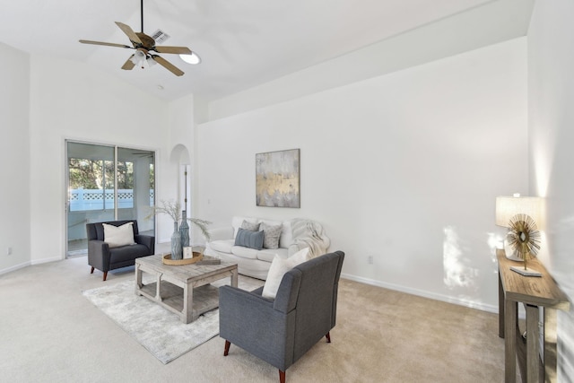 581 Boxwood Pl, Saint Augustine, FL 32086 - living room featuring light carpet, a ceiling fan, arched walkways, and high vaulted ceiling
