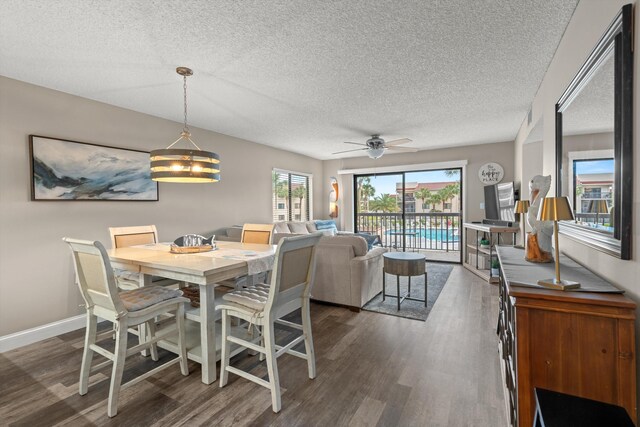 4250 A1A S E26, Saint Augustine, FL 32080 - dining space featuring dark wood-type flooring, a textured ceiling, ceiling fan, and a chandelier
