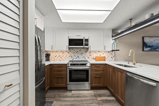 4250 A1A S E26, Saint Augustine, FL 32080 - kitchen featuring appliances with stainless steel finishes, dark wood-style floors, white cabinetry, and tasteful backsplash