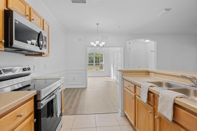 kitchen featuring hanging light fixtures, stainless steel appliances, light tile patterned flooring, a chandelier, and crown molding