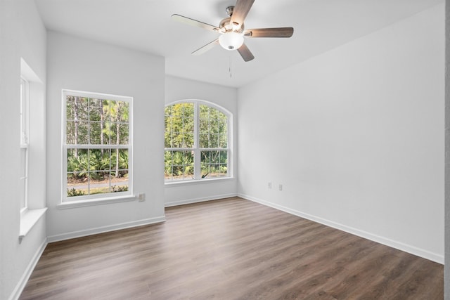 unfurnished room featuring ceiling fan and dark hardwood / wood-style flooring