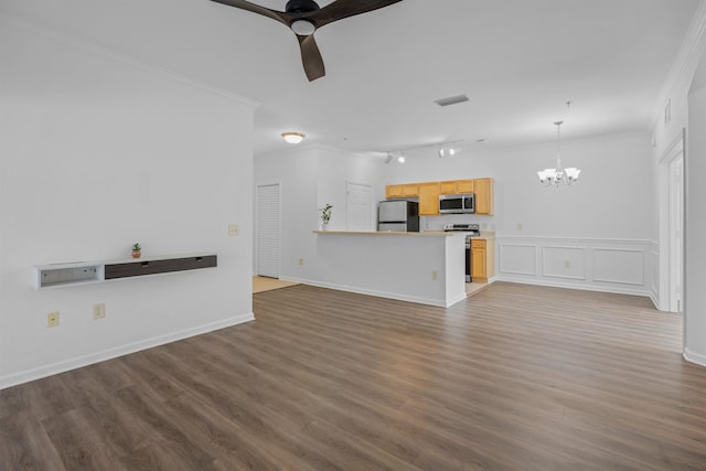 unfurnished living room with dark wood-type flooring, track lighting, crown molding, and ceiling fan with notable chandelier