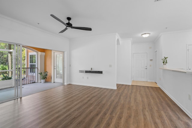 unfurnished living room with ornamental molding, dark wood-type flooring, and ceiling fan