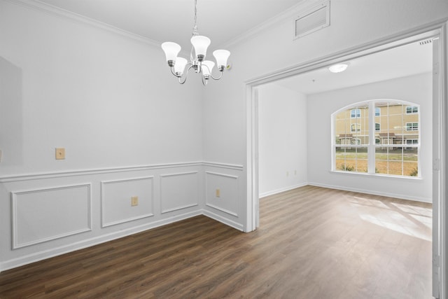 unfurnished dining area with ornamental molding, dark wood-type flooring, and a chandelier