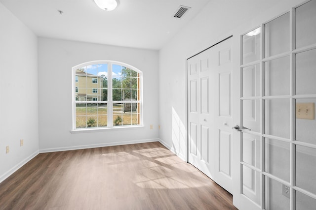 unfurnished bedroom with hardwood / wood-style flooring and a closet