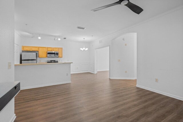 unfurnished living room with ornamental molding, dark wood-type flooring, and ceiling fan with notable chandelier