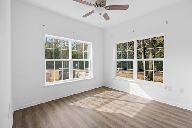 empty room with hardwood / wood-style floors and ceiling fan