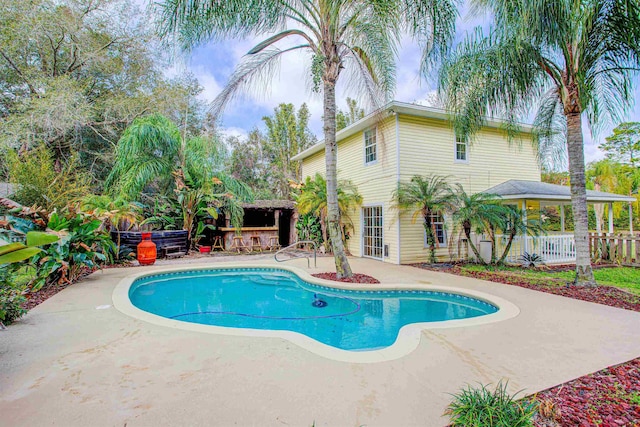 543 Ray Edwards Rd, Saint Augustine, FL 32086 - traditional-style house featuring a chimney, covered porch, fence, a shingled roof, and a front yard