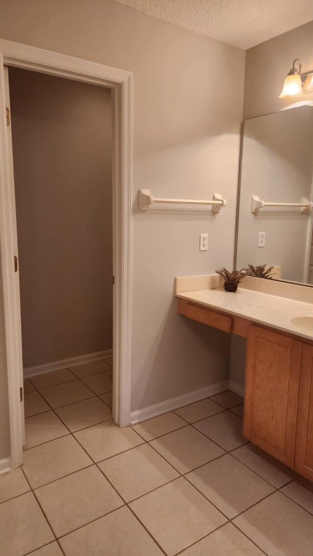 708 Blackmoor Gate Ln, Saint Augustine, FL 32084 - bathroom with a textured ceiling, tile patterned floors, baseboards, and vanity