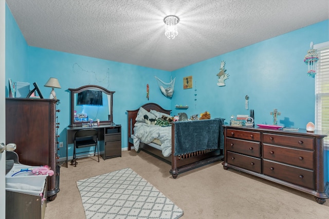 bedroom featuring light carpet and a textured ceiling