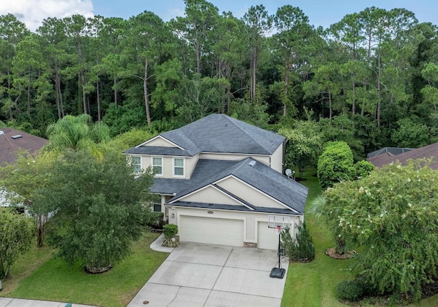 view of front of home with a garage and a front lawn