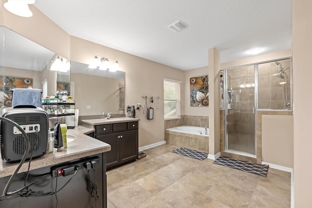 bathroom featuring tile patterned flooring, vanity, a textured ceiling, and shower with separate bathtub