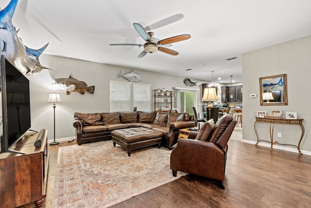 living room featuring hardwood / wood-style floors and ceiling fan