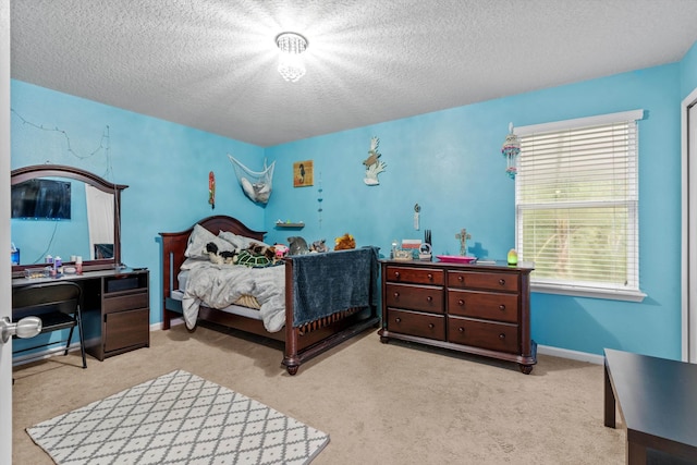 bedroom featuring light colored carpet and a textured ceiling