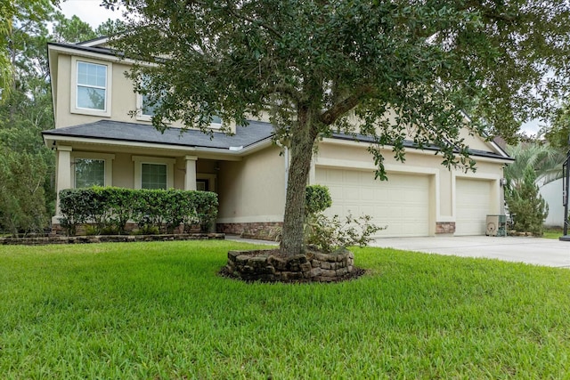 view of front of house featuring a garage and a front lawn