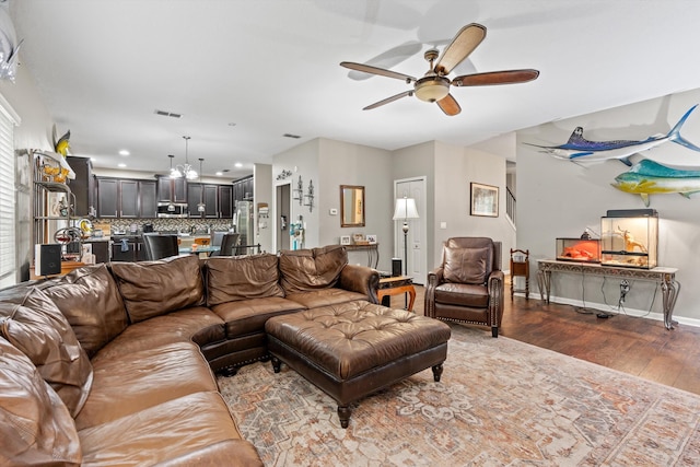 living room with wood-type flooring and ceiling fan