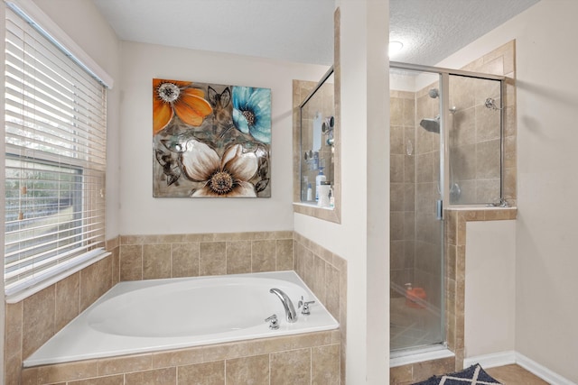 bathroom with a textured ceiling and plus walk in shower