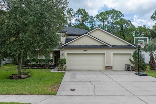 view of front of home featuring a front yard and a garage