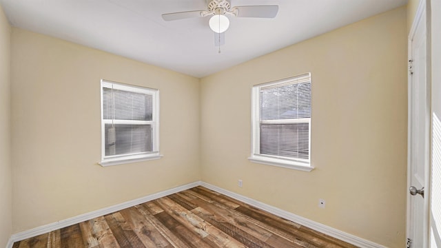 spare room with ceiling fan and dark hardwood / wood-style flooring