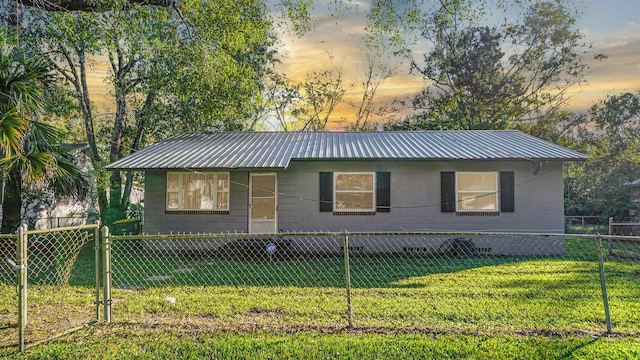 ranch-style home with a lawn