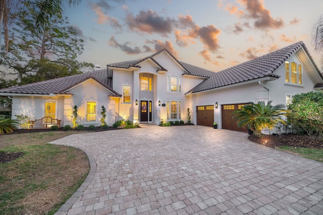 mediterranean / spanish house with a garage