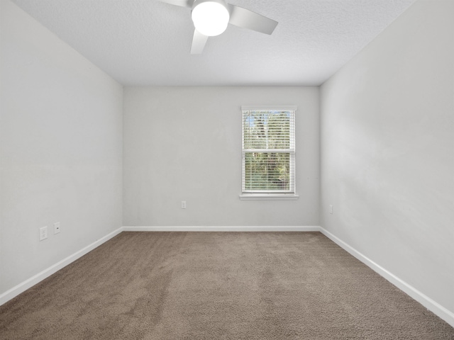 empty room with a textured ceiling, carpet floors, and ceiling fan