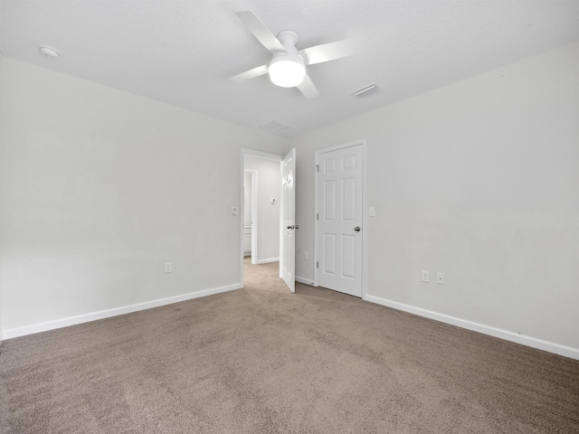 empty room with ceiling fan and carpet floors