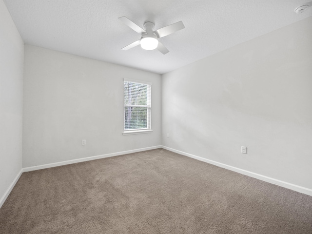 unfurnished room with ceiling fan, carpet floors, and a textured ceiling