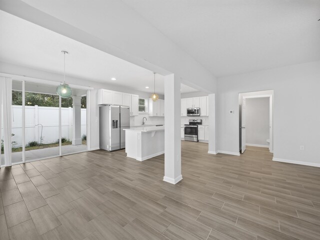 unfurnished living room with light hardwood / wood-style floors and sink