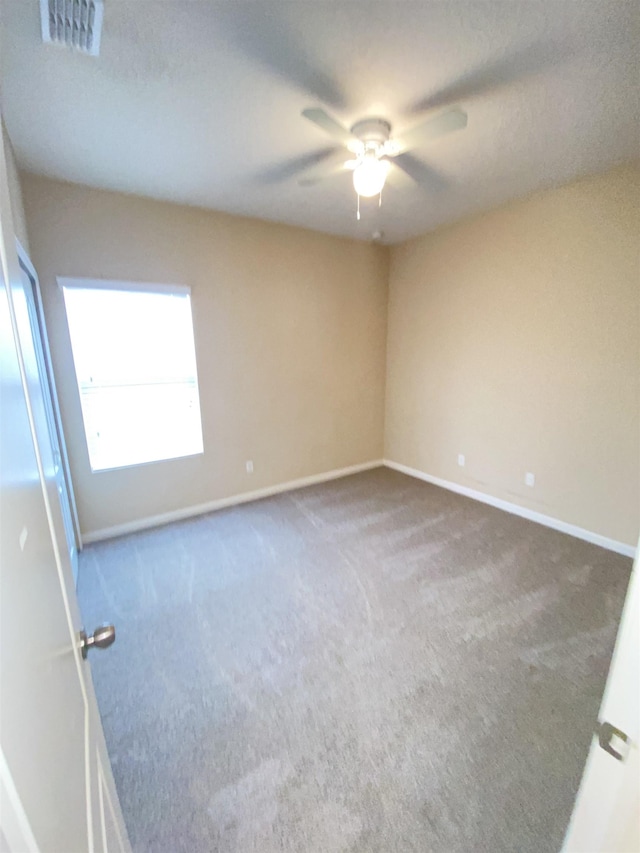 empty room with carpet floors and ceiling fan