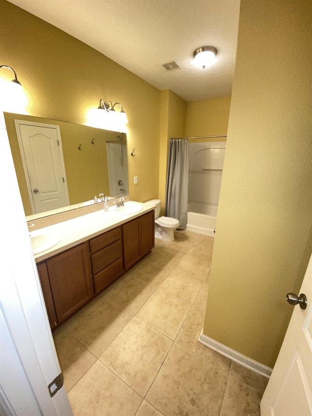 full bathroom with shower / bath combo, tile patterned flooring, a textured ceiling, toilet, and vanity