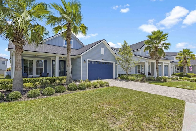 view of front of property with a garage and a front yard