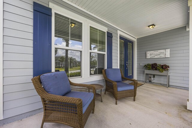 property entrance featuring covered porch and french doors