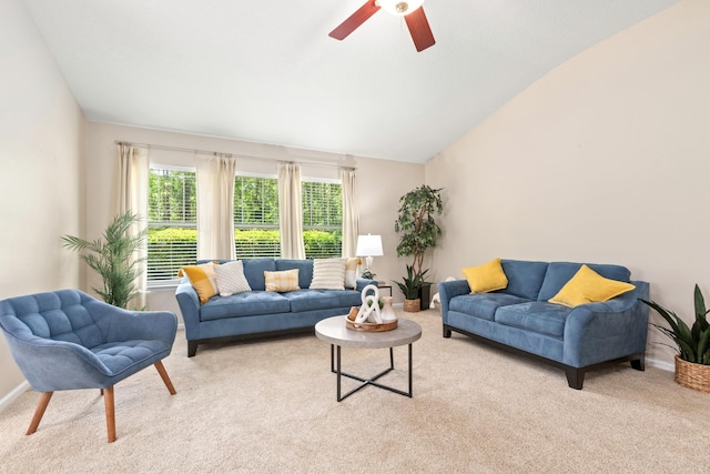 living room with carpet floors, a ceiling fan, vaulted ceiling, and baseboards