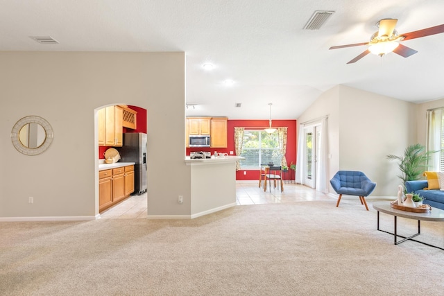 living area with light colored carpet, baseboards, a ceiling fan, and vaulted ceiling