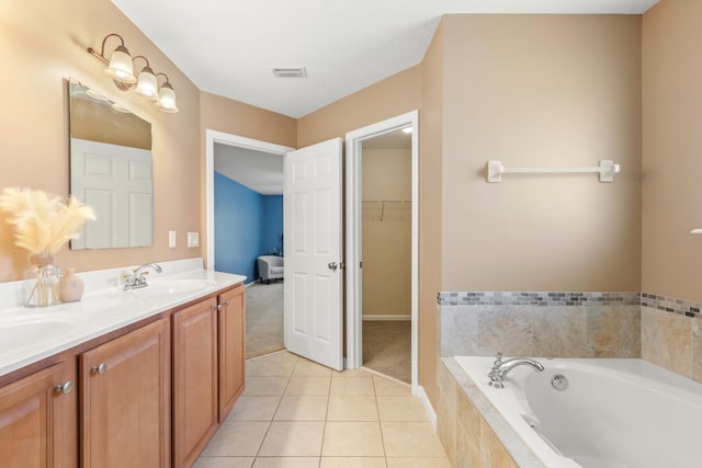 bathroom featuring a bath, double vanity, tile patterned floors, and a spacious closet
