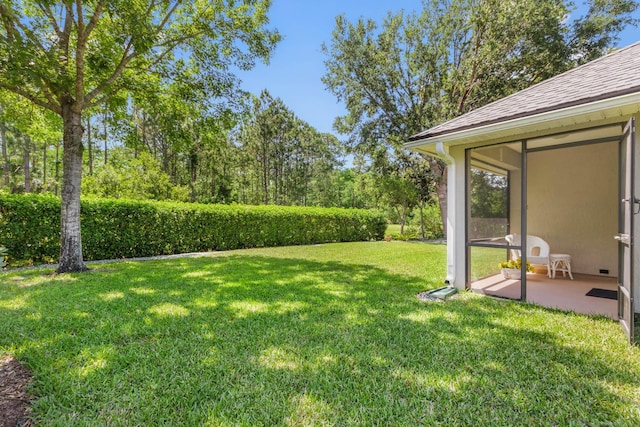 view of grassy yard with a patio