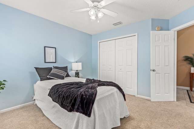 bedroom featuring a closet, carpet, baseboards, and a ceiling fan