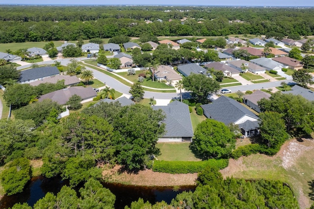 aerial view of property's location featuring nearby suburban area and a nearby body of water