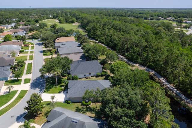 aerial perspective of suburban area featuring a heavily wooded area