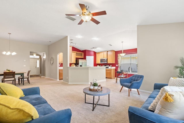 living room with ceiling fan, lofted ceiling, light carpet, arched walkways, and baseboards
