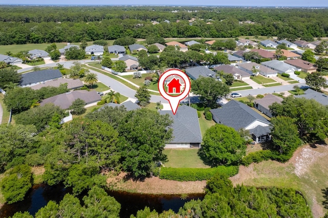 aerial view of property's location featuring nearby suburban area and a nearby body of water
