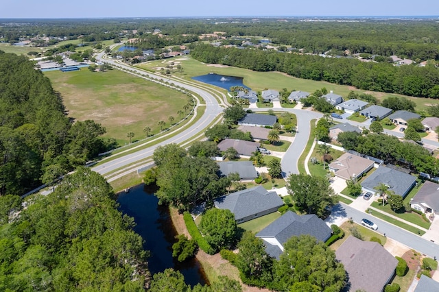 aerial view of property's location with a large body of water and nearby suburban area