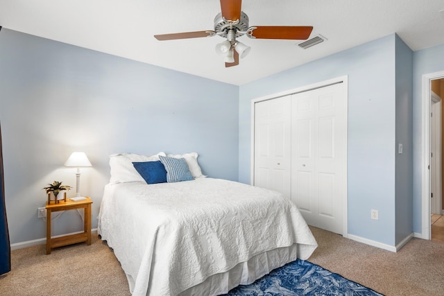 bedroom with carpet flooring, a closet, baseboards, and a ceiling fan