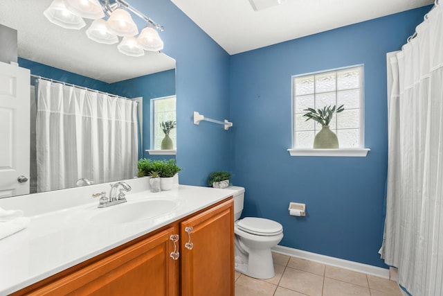 bathroom featuring tile patterned floors, toilet, vanity, and baseboards