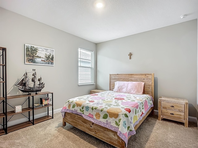 bedroom with carpet floors and baseboards