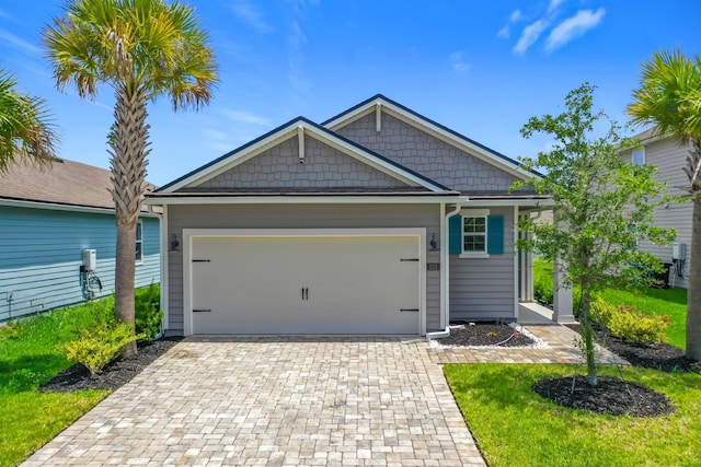 view of front facade with decorative driveway and a garage
