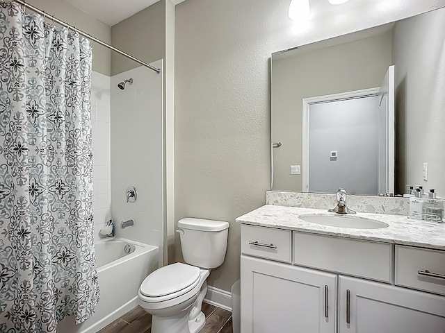 full bathroom with wood finished floors, toilet, shower / bathtub combination with curtain, vanity, and baseboards